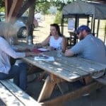 Mary Luton discusses puppy adoption packet with adopters