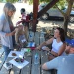 Mary going over the contents of goodie bag with resce puppy Iris adopters