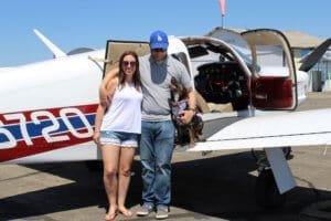 Rescue Ranch this year, Family shot with puppy next to small plane