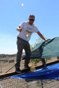 Team member, Ari on kennel roof, Lava Fire