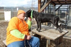 Amazing dog Benny up on picknic table kissing Steven's face