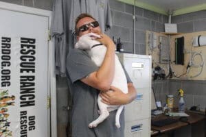Team member, Ari hugging Ash during foster visit at adoption center