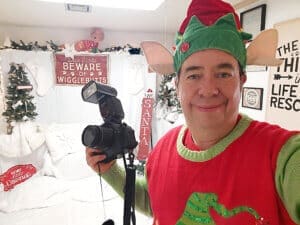 Rescue Ranch volunteer, Eric as an elf takling pictures for Satna Paws