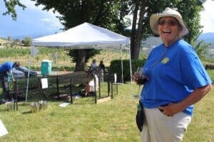 Rescue Ranch volunteer, Judy, tastes Naumes wine at the end of July 4 event