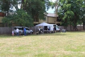 Dog adoptions, Rescue Ranch Team setting up on lawn, wide shot