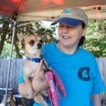 Oldies volunteer Julie with Mazi at Red Dog Pet Supply Puppy Pool and Adoption Event