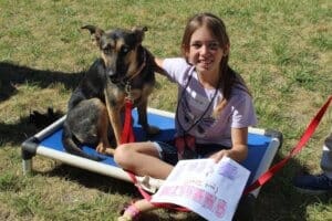 Dog socialization training camp_Annalyn sitting on cot with Mira