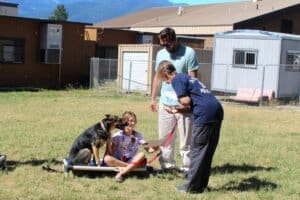 Dog socialization training camp_Karen Topping handing out graduation certificates