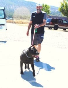 Right home_Onyx excited pulling on leash with new dad behind