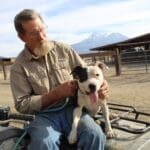 Pit Bull Awareness Month, Ramona posing on John Glay's lap on ATV