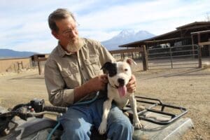 Pit Bull Awareness Month, Ramona posing on John Glay's lap on ATV