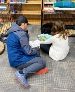 Family reading to pup