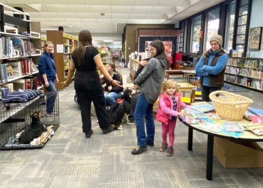 ws Karen_visitors_ and crated pup in library
