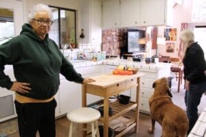 Dog rescuers in the kitchen with Woody