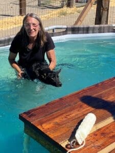 Laura in pool with adult dog