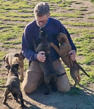Marc_with_malinois_puppies